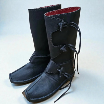 Black handmade medieval leather boots with wrap laces, red lining, and visible stitching, crafted for LARP and SCA reenactment.